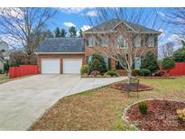 Charming two-story brick home features a two-car garage and a beautifully landscaped front yard at 1511 35Th Ne Ave, Hickory, NC 28601