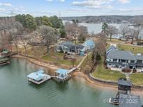 Scenic aerial view of waterfront home, private boat dock, and inviting lake access at 246 Apache Rd, Troutman, NC 28166