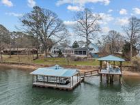 Waterfront home with a private boat dock, including boat lift and covered seating area, along the shores of Lake Wylie at 246 Apache Rd, Troutman, NC 28166