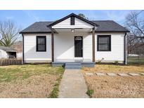 Charming house with a classic black and white color scheme and a well-maintained front yard at 1110 Alexander St, Statesville, NC 28677