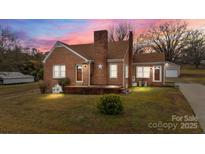 Charming brick home with a well-maintained lawn and beautiful twilight sky at 1489 Riley St, Albemarle, NC 28001