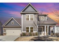 Charming two-story home featuring a well-manicured lawn and an attached two-car garage at 15319 Venezia Ln, Huntersville, NC 28078