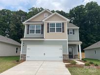 Charming two-story home features a two-car garage and welcoming front porch at 3263 Maple Ridge Dr, Gastonia, NC 28052