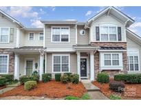 Charming townhome with stone accents, manicured landscaping, and a welcoming front entrance at 706 Cherryfield Pl, Rock Hill, SC 29732