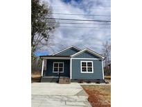 Charming single-story home with blue siding and white trim, complemented by a concrete driveway at 1530 W Horah St, Salisbury, NC 28144