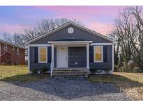 Charming bungalow with gray siding, white trim, and a cozy front porch and fresh landscaping at 235 8Th Avenue Sw Dr, Hickory, NC 28602