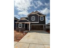 Beautiful two-story home featuring a two-car garage and stylish gray siding and complementary trim at 330 Knotty Wood Dr # 67, Monroe, NC 28110