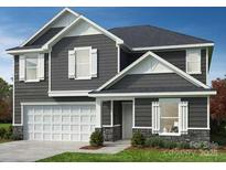Charming two-story home with gray siding, white trim, and a two-car garage at 330 Knotty Wood Dr # 67, Monroe, NC 28110