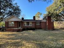 Charming single-story brick home featuring a classic design and inviting front porch at 3694 Nc Highway 109 S Hwy, Mount Gilead, NC 27306