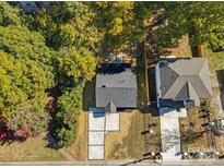 An aerial view of a home with mature trees, manicured lawn and a driveway at 3717 Marvin Rd, Charlotte, NC 28211