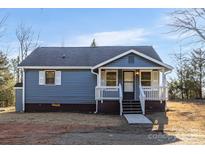 Charming one-story home with blue siding, white trim, and a welcoming front porch at 445 Cannon Farm Rd, China Grove, NC 28023