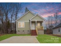 Charming single Gathering home with a covered front porch, lovely landscaped yard and private driveway at 451 Geroid St, Salisbury, NC 28144