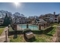 Aerial shot of the pool area shows lush landscaping and surrounding buildings at 5009 Sharon Rd # E, Charlotte, NC 28210