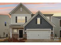 Charming two-story home featuring a two-car garage, stone accents, and warm exterior lighting at 6509 Gopher Rd, Lancaster, SC 29720