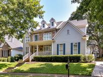 Charming two-story home with stone and siding exterior and a welcoming front porch at 9409 Gilpatrick Ln, Huntersville, NC 28078