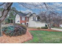 Charming two-story home with a blend of siding and brick accents, complemented by a well-maintained front yard at 9717 Spring Park Dr, Charlotte, NC 28269