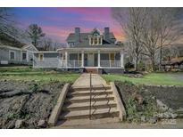 Charming blue two-story home with a welcoming front porch and lush green lawn at 116 Rose Ter, Wadesboro, NC 28170