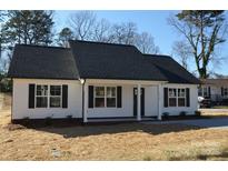 Charming single-story home featuring a new roof, white siding, black shutters, and manicured lawn at 1410 Meadow Ave, Kannapolis, NC 28083