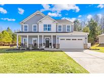 Charming two-story home with a welcoming porch, a two-car garage, and a well-maintained lawn at 146 Allenton Way, Statesville, NC 28677