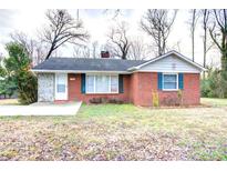 Charming single-story brick home with green shutters and a well-maintained front yard at 154 Bingham Dr, Charlotte, NC 28213