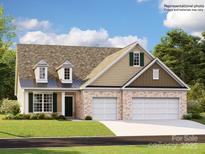 Charming single Gathering home featuring a brick facade and a two-car garage at 1566 Croydon St, Indian Land, SC 29707