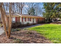 Charming single-story brick home with a well-maintained lawn and traditional architectural details at 1825 Hyatt Ave, Rock Hill, SC 29732