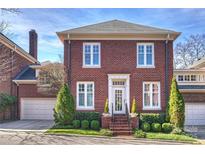 Charming brick home featuring manicured landscaping, updated windows, and a welcoming front entrance at 2010 Nolen Park Ln, Charlotte, NC 28209