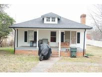 Charming single-story home with a cozy front porch and a well-maintained brick foundation at 2204 W Second Ave, Gastonia, NC 28052