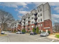 Modern condo building with brick and steel, featuring private balconies and ample parking at 2338 Yadkin Ave # 205, Charlotte, NC 28205