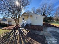 Charming single story home with a covered front porch, mature trees, and inviting curb appeal at 2840 James St, Charlotte, NC 28208