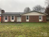 Charming single-story brick home featuring cozy curb appeal and an inviting front yard at 3003 Winston Nw Dr, Concord, NC 28027