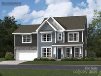 New construction, two story home with gray horizontal siding, stone accents, and an attached garage at 3907 Horsham St, Indian Land, SC 29707