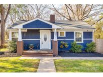 Charming blue home with covered front porch and manicured landscaping at 119 N Smallwood Pl, Charlotte, NC 28216