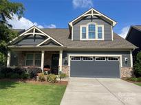 Charming two-story home featuring stone accents, a two-car garage, and beautifully landscaped front yard at 1284 Independence St, Tega Cay, SC 29708