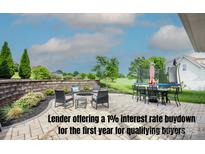 Charming outdoor patio with comfortable seating, a fire pit, and views of the backyard at 137 Tenth Green Ct, Statesville, NC 28677