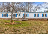 Charming single-story home featuring a blue metal roof and blue shutters enhancing its curb appeal at 1691 Hopewell Church Rd, Catawba, NC 28609