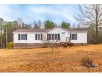 Charming one-story home featuring a cozy front porch and well-maintained landscaping on a large lot at 1912 Beach Ln, Heath Springs, SC 29058