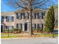 Charming brick townhouse featuring black shutters, manicured landscaping, and a well-maintained front yard at 19249 Lake Norman Cove Dr, Cornelius, NC 28031