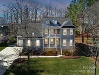 Charming two-story home featuring a welcoming front porch and beautifully landscaped yard at 208 Cape August Pl, Belmont, NC 28012