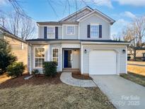 Charming two-story home featuring a well-manicured lawn, inviting entrance, and attached garage at 3161 Glen Robin Ct, Charlotte, NC 28205