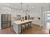 Gorgeous kitchen features a large island, stainless steel appliances, and ample cabinet space at 4159 Millstream Rd, Denver, NC 28037