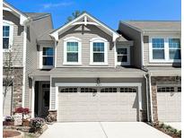Charming townhouse featuring a neutral color palette, decorative stone accents, and a two-car garage at 4769 Darcey Way, Indian Land, SC 29707