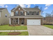 Beautiful two-story home featuring a two-car garage, brick facade, and well-manicured front lawn at 5735 Olive Beach Rd, Kannapolis, NC 28081