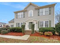 Charming two-story home featuring green shutters, mature landscaping, and a welcoming entrance at 609 Sunset Point Dr, Rock Hill, SC 29732