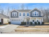 Charming two-story home with a two-car garage and covered front porch at 7535 Meridale Forest Dr # 107, Charlotte, NC 28269