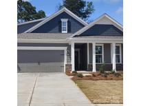 Charming single-Gathering home with a gray garage, gray siding, and a inviting front porch with brick accents at 113 Noah Ln, Troutman, NC 28166