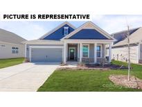 Charming home featuring a well-maintained lawn, a grey two-car garage, and a welcoming front porch at 117 Noah Ln, Troutman, NC 28166