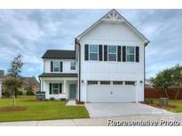 Charming two-story home features a welcoming front porch and an attached two-car garage at 265 Red Fox Ln # 1P, China Grove, NC 28023