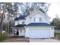 Charming two-story home with a two-car garage, cozy front porch, and well-maintained landscaping at 312 Radio Rd, Charlotte, NC 28216