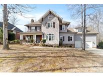 Charming two-story home showcasing beautiful architectural details and a welcoming front yard at 4915 Ardenwoods Dr, Charlotte, NC 28215
